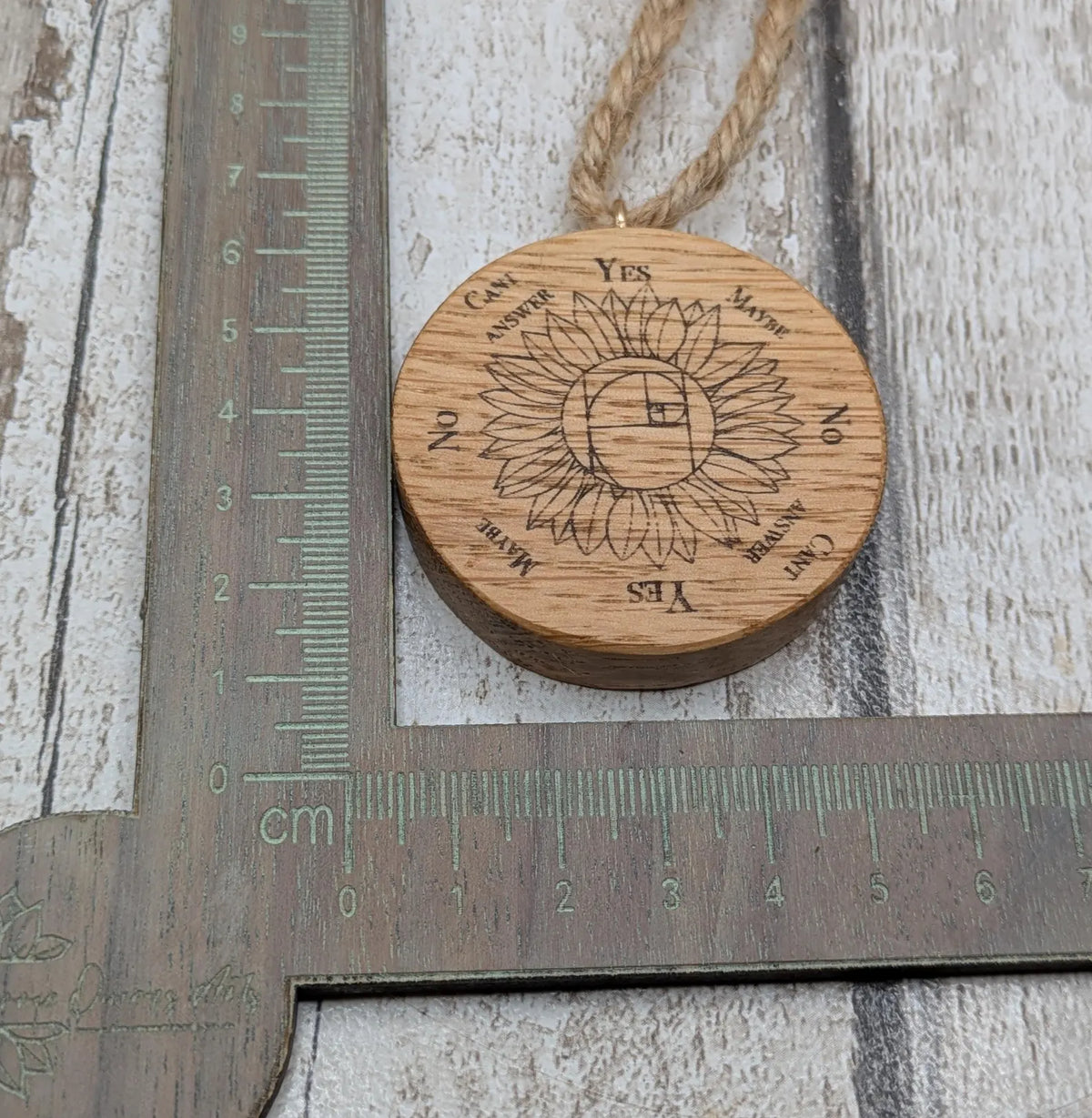 Oak wood mini pocket pendulum board with sunflower design.