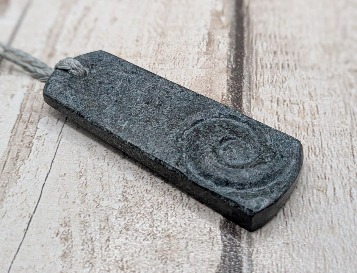 Statement preselli bluestone koru spiral pendant.