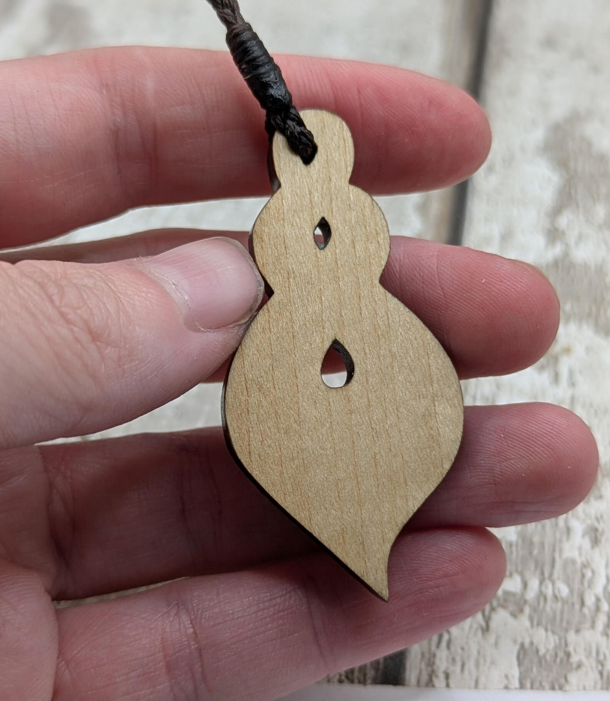 Lime wood, laser printed and cut pikorua pendant.