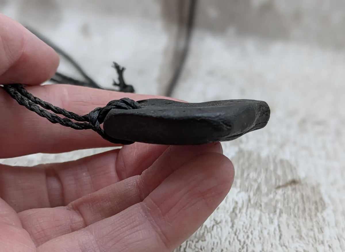 Naturally tumbled Whitby jet pendant.