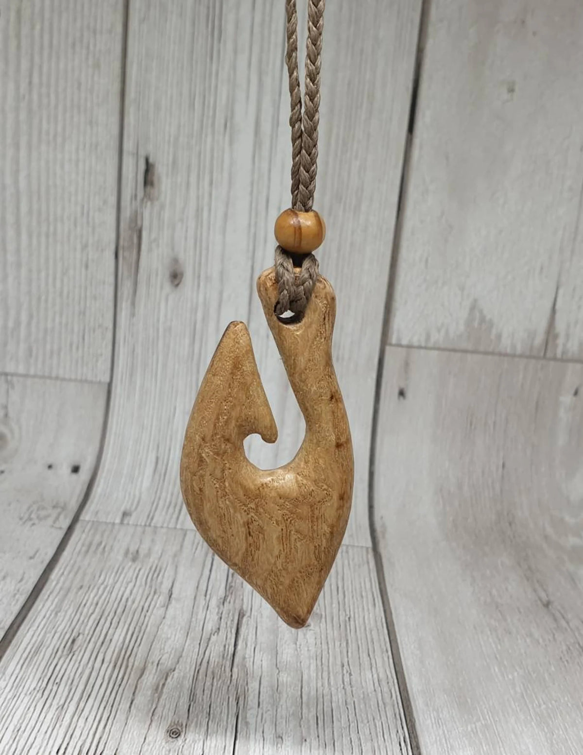 Ash wood hei matau fish hook pendant.