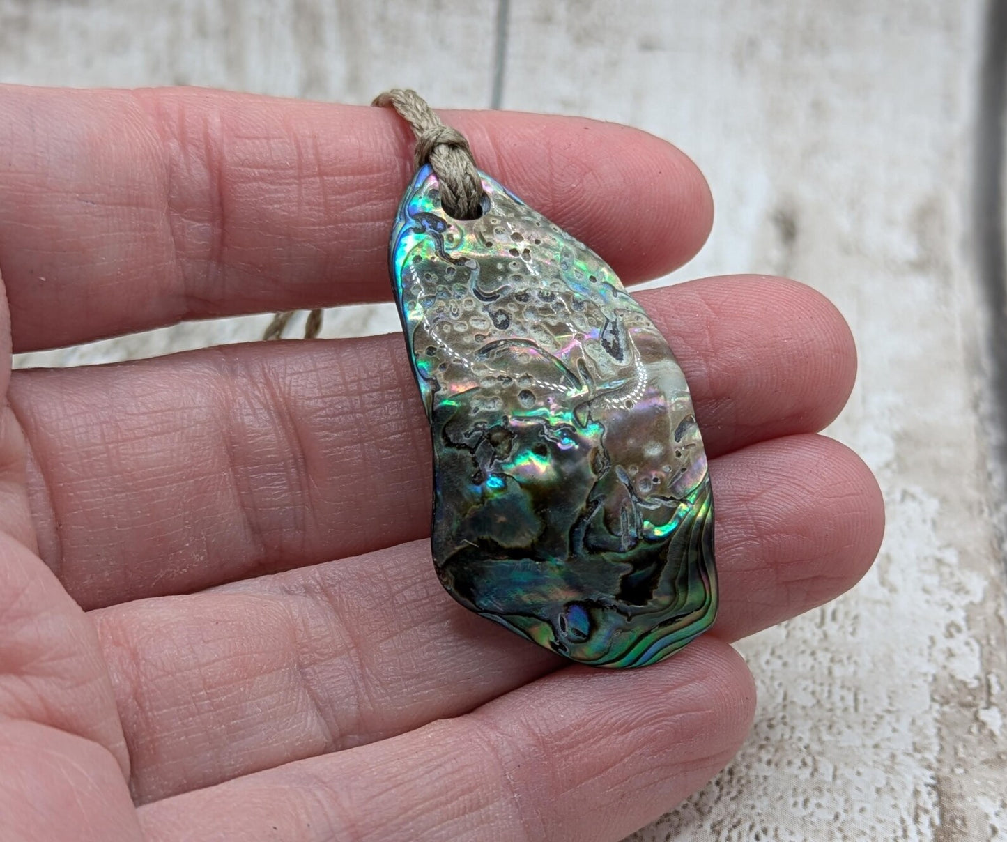 New Zealand free form wild tumbled rainbow Pāua pendant.