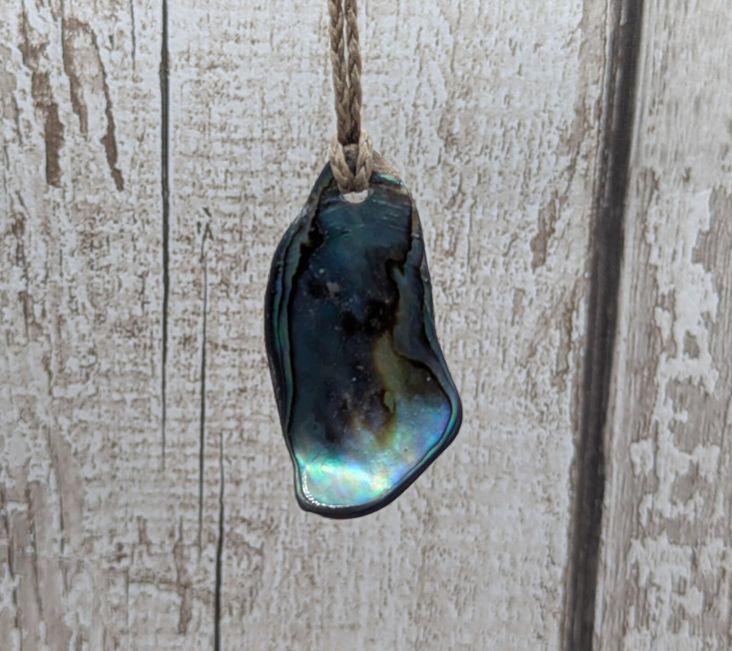 New Zealand free form wild tumbled rainbow Pāua pendant.