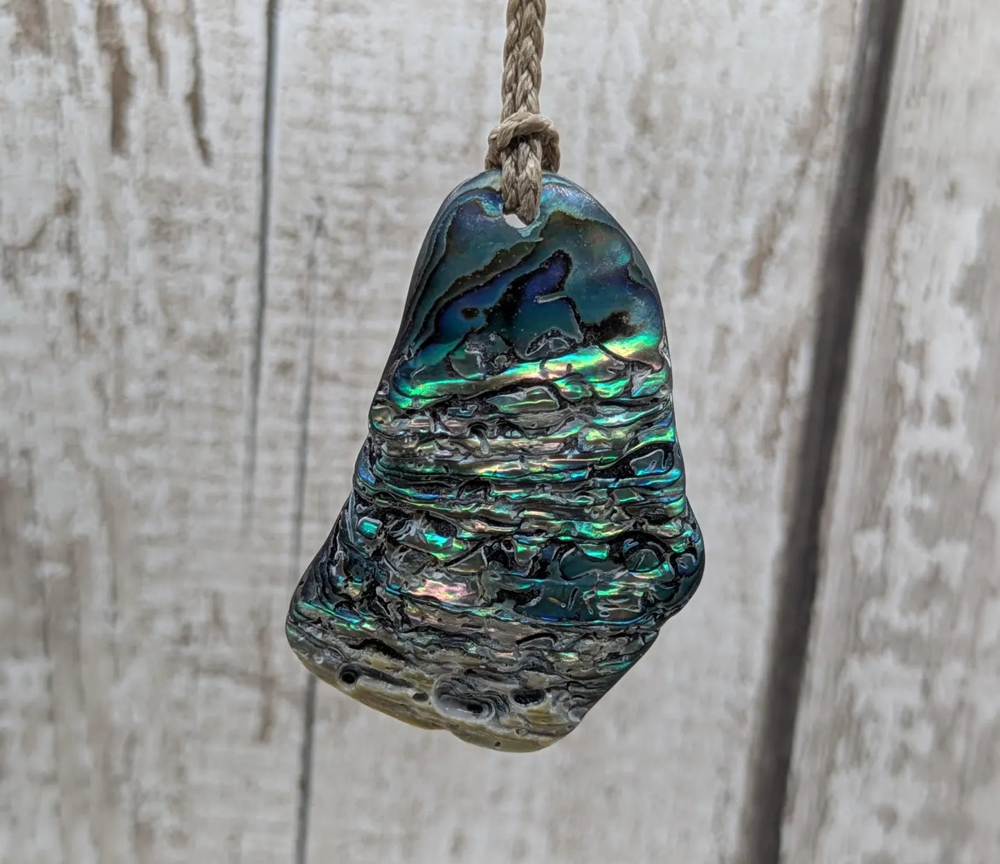 New Zealand free form naturally tumbled Pāua shell pendant.