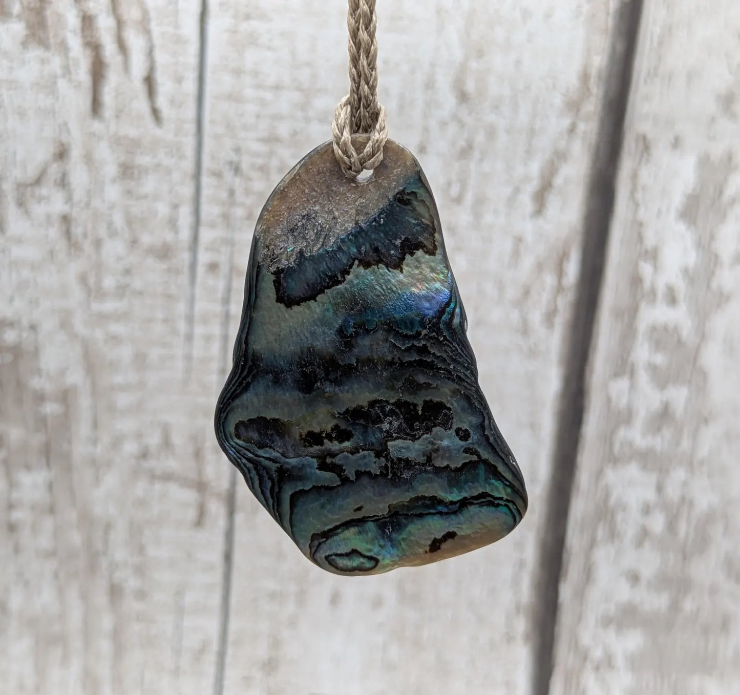 New Zealand free form naturally tumbled Pāua shell pendant.