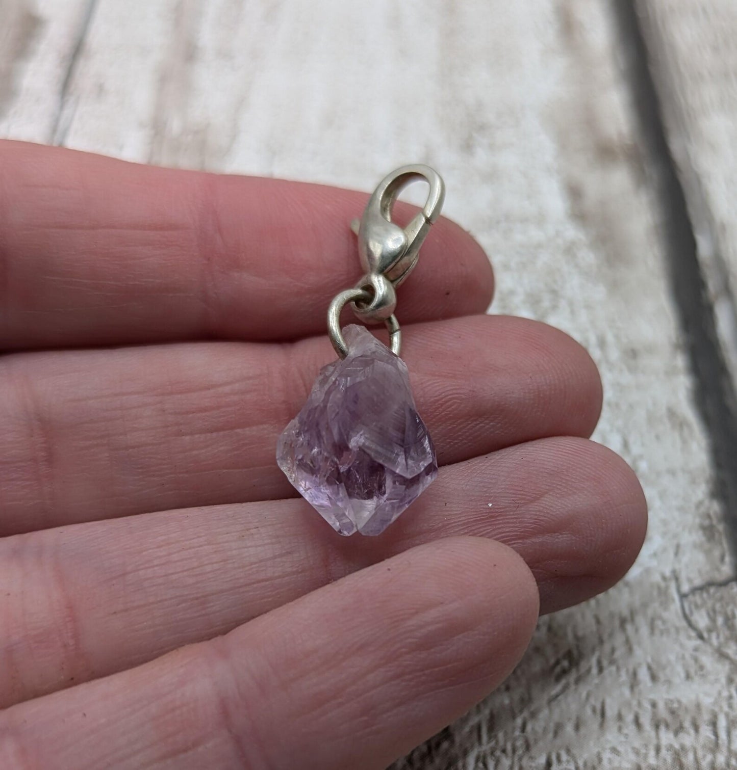 Raw amethyst point clip on charm.