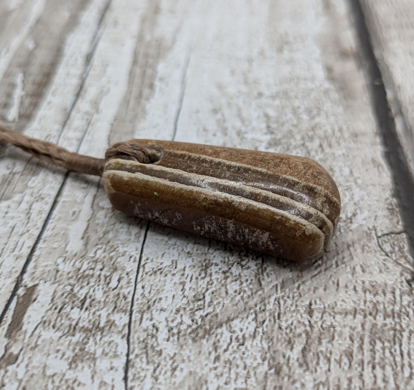 Striped argonite roimata teardrop pendant.