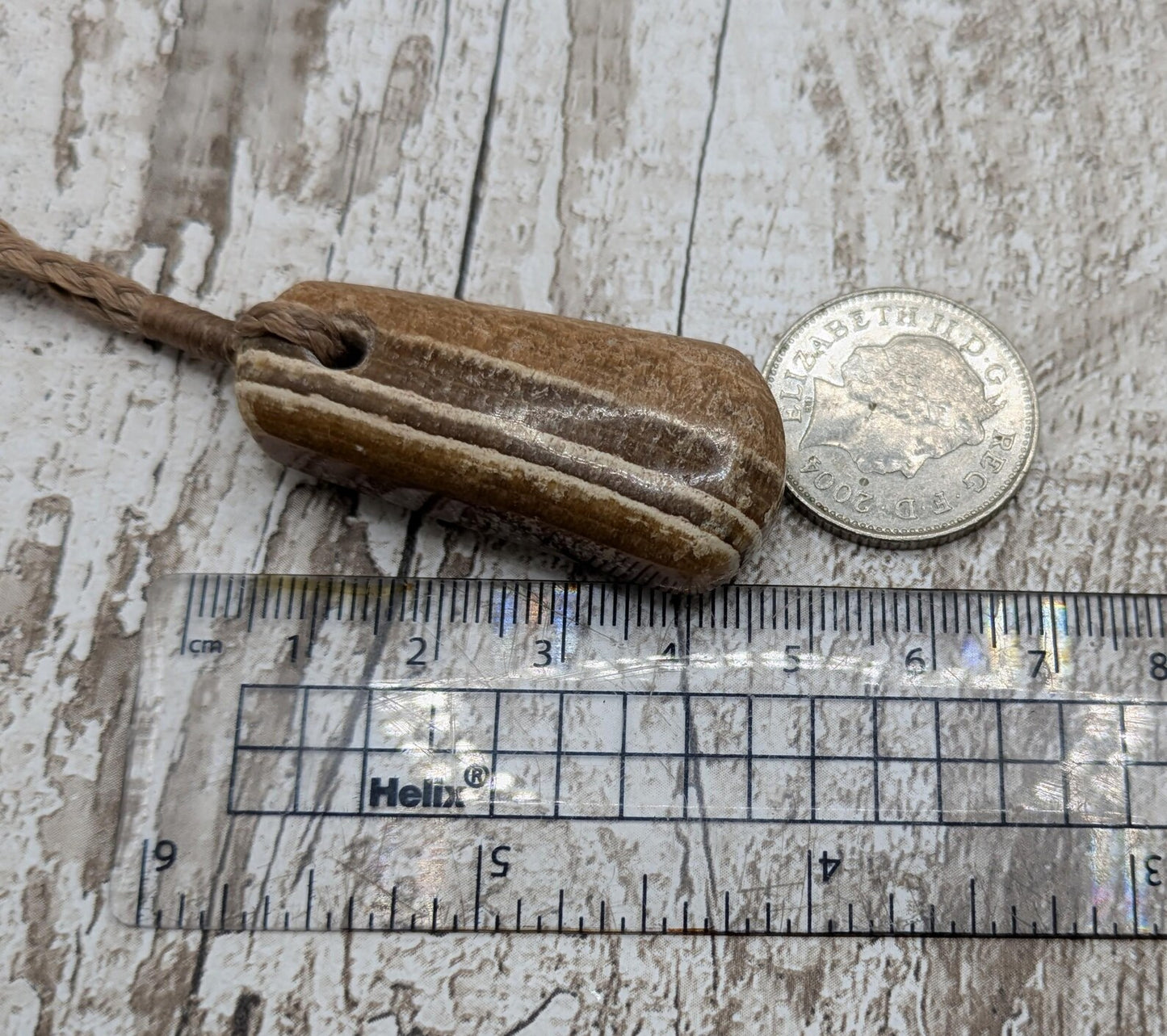 Striped argonite roimata teardrop pendant.