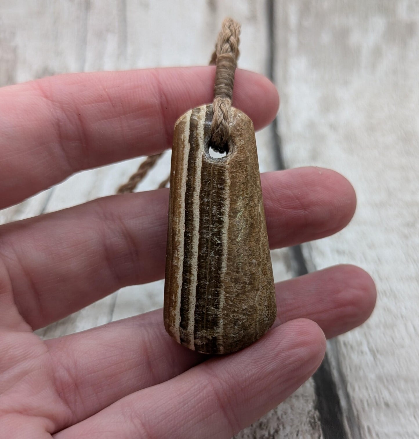 Striped argonite roimata teardrop pendant.