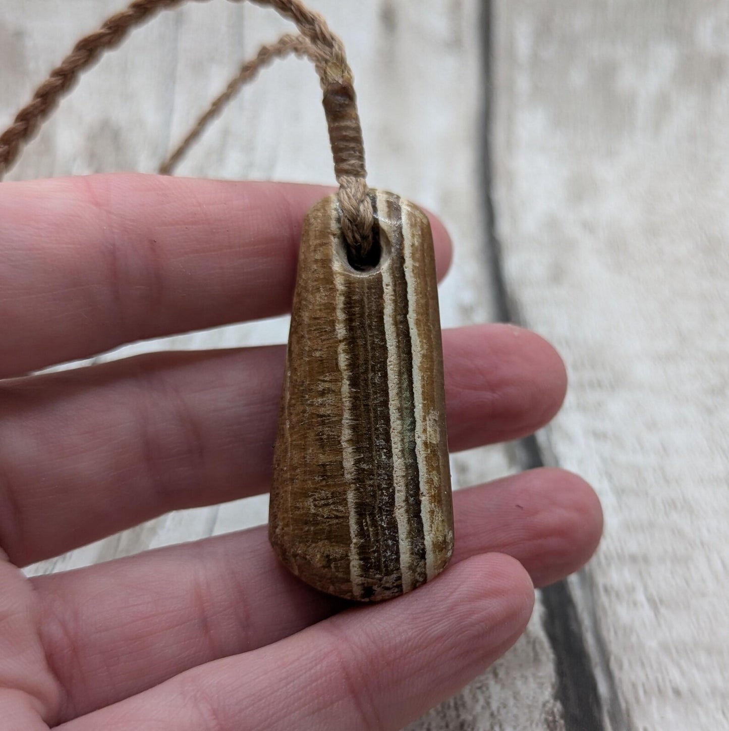 Striped argonite roimata teardrop pendant.