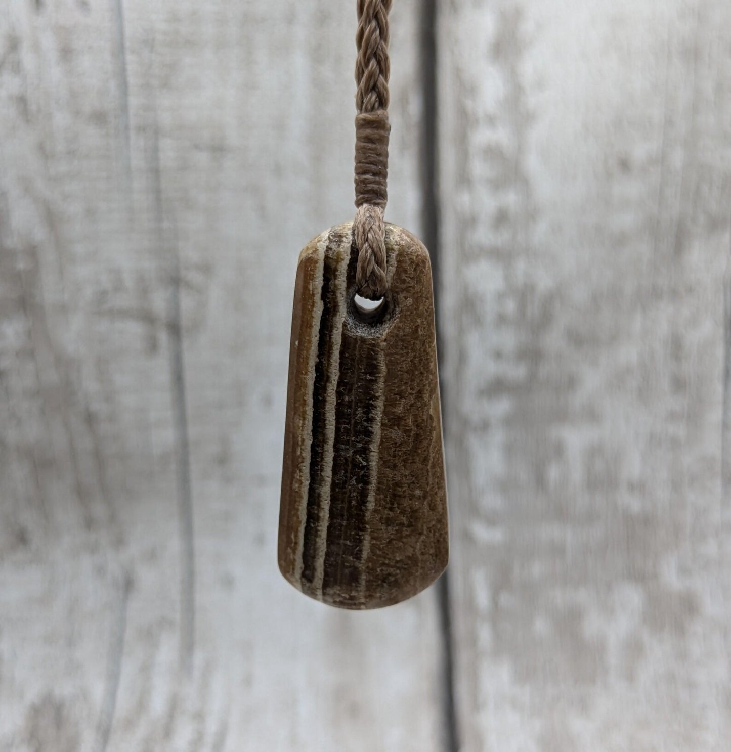 Striped argonite roimata teardrop pendant.