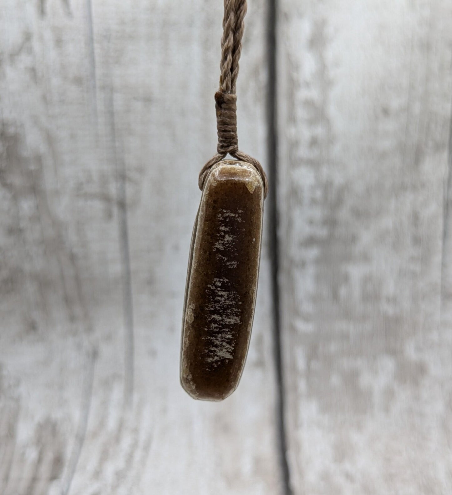Striped argonite roimata teardrop pendant.