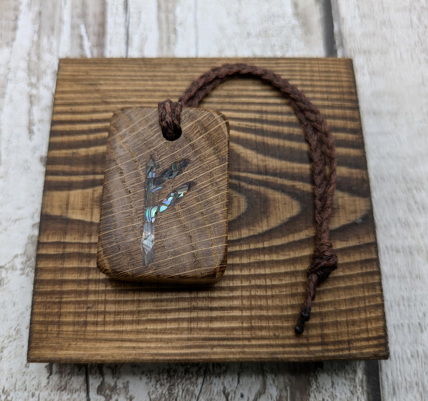Oak wood Fehu rune Christmas decorations with rainbow Pāua.