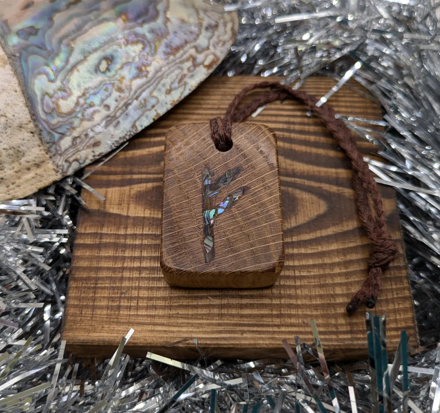 Oak wood Fehu rune Christmas decorations with rainbow Pāua.