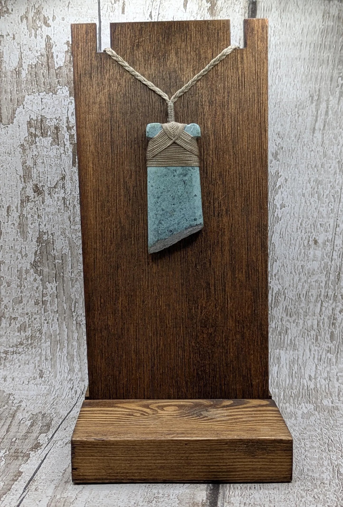 New Zealand Pounamu greenstone jade Hei Toki adze pendant with raw live edges.