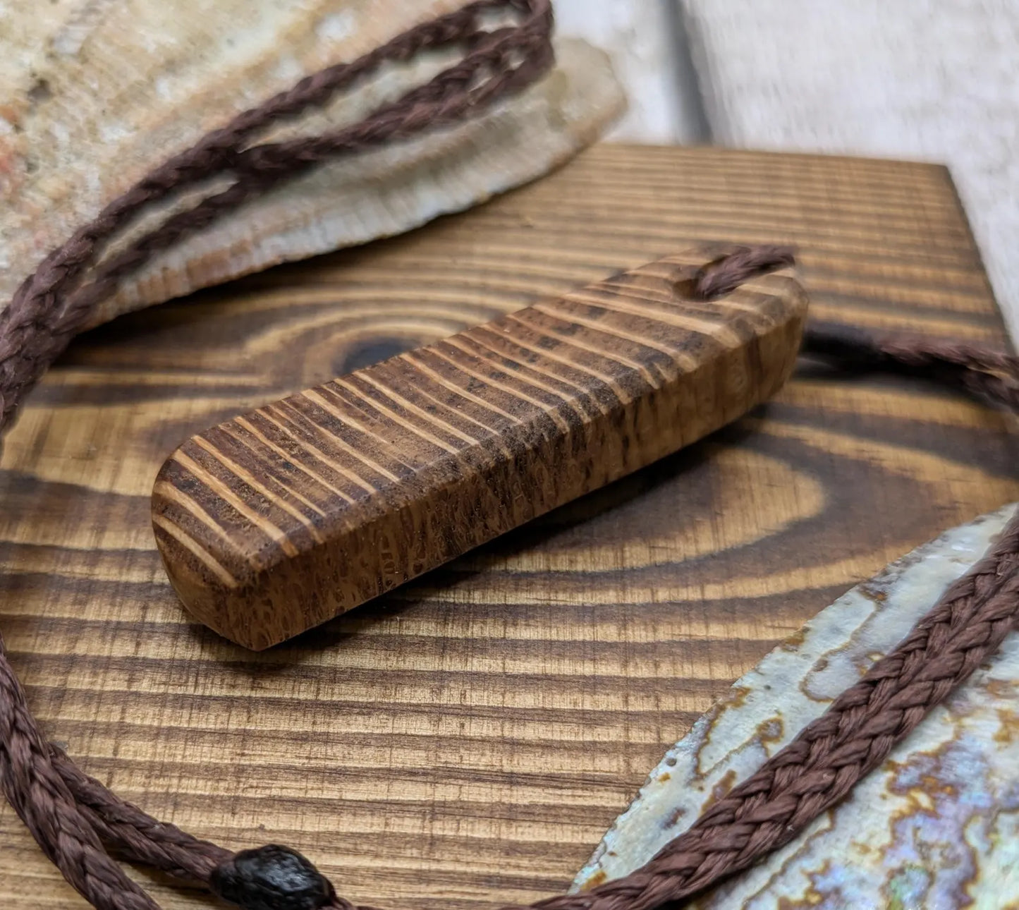 Olive wood roimata teardrop pendant.