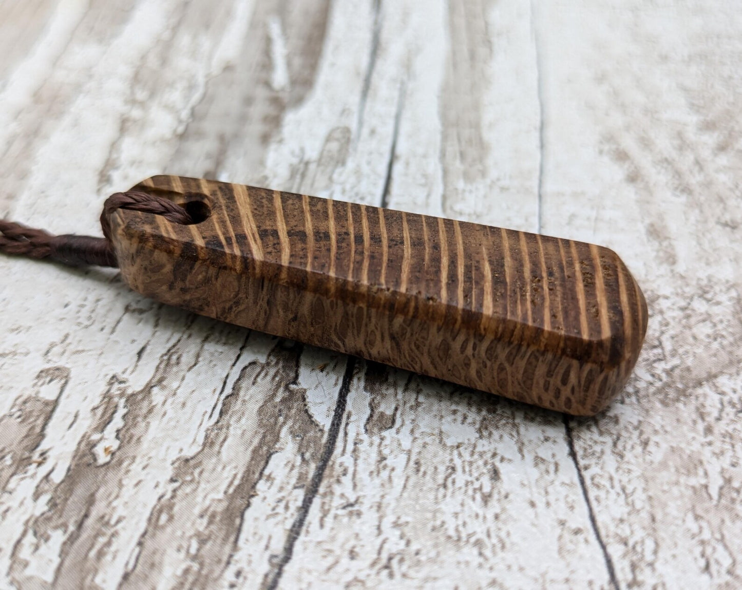 Olive wood roimata teardrop pendant.