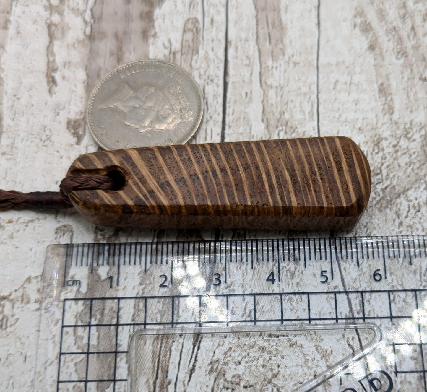 Olive wood roimata teardrop pendant.