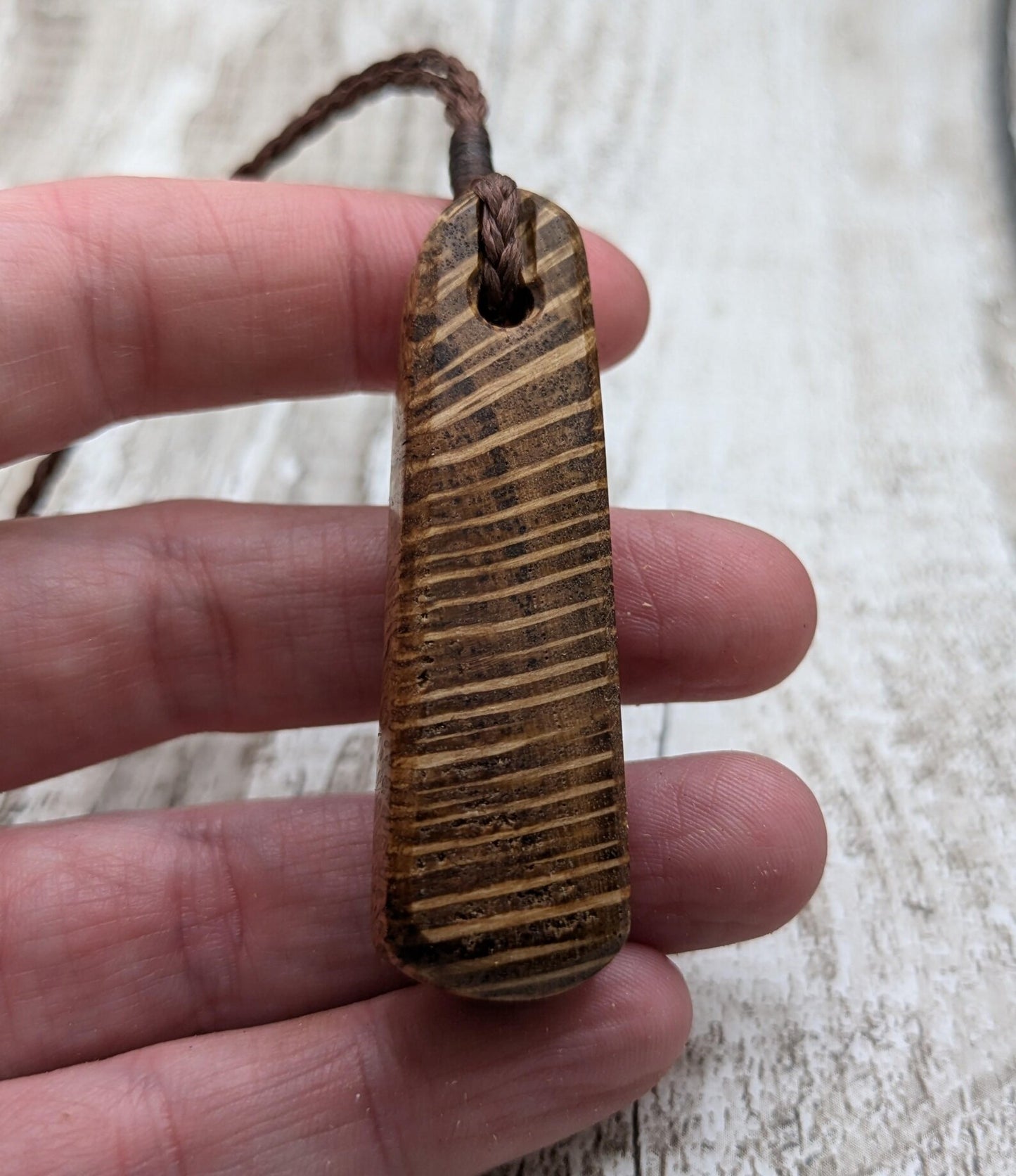 Olive wood roimata teardrop pendant.