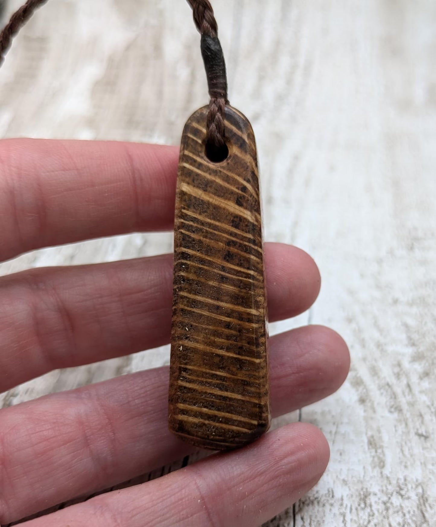 Olive wood roimata teardrop pendant.