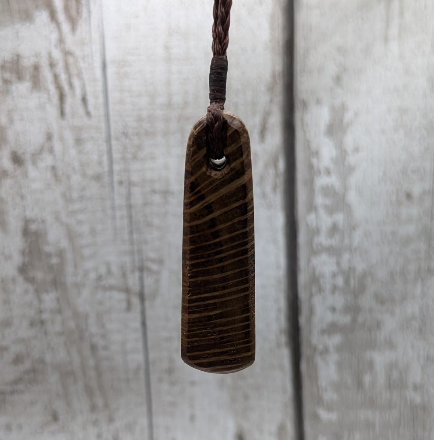 Olive wood roimata teardrop pendant.