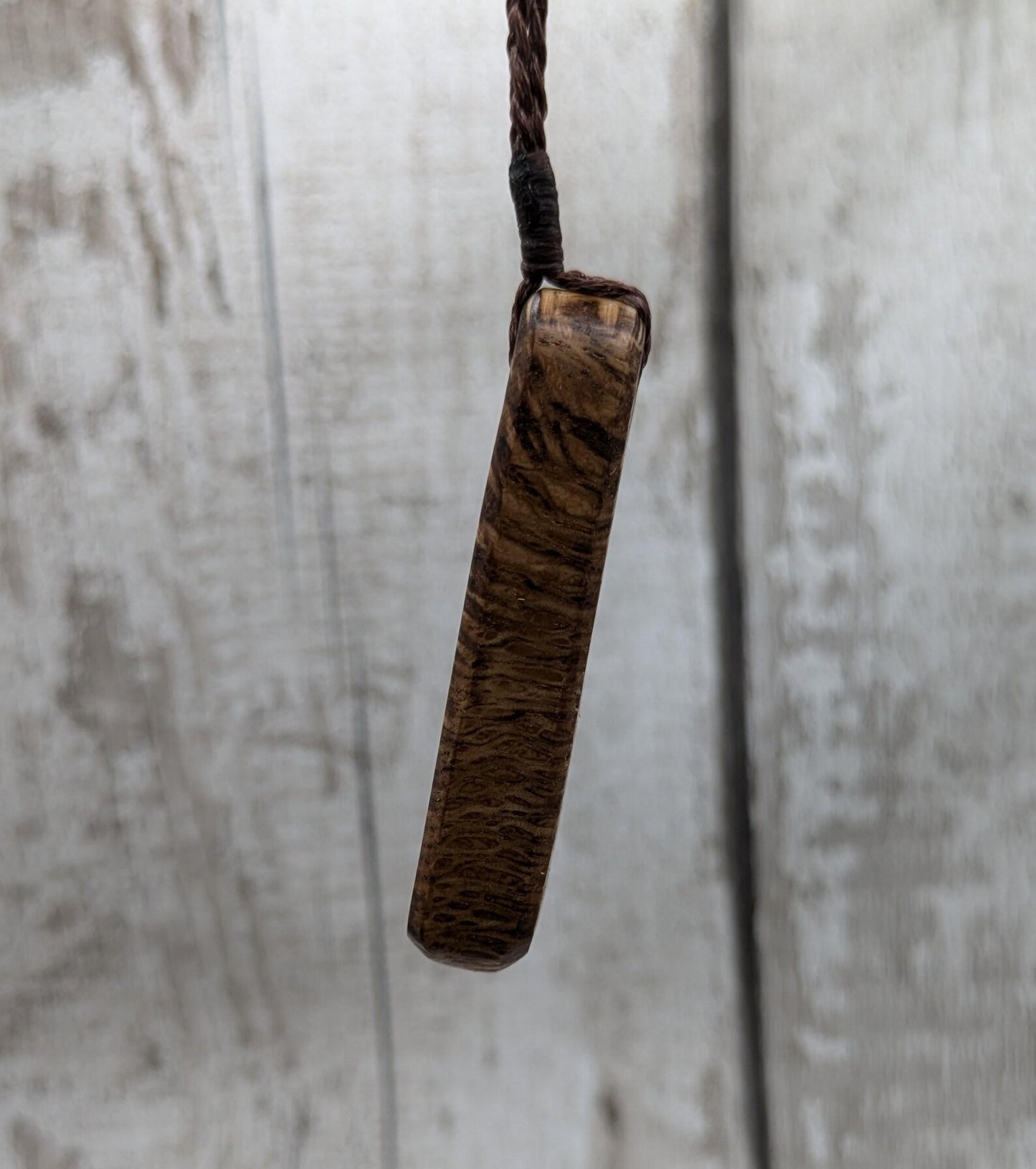 Olive wood roimata teardrop pendant.