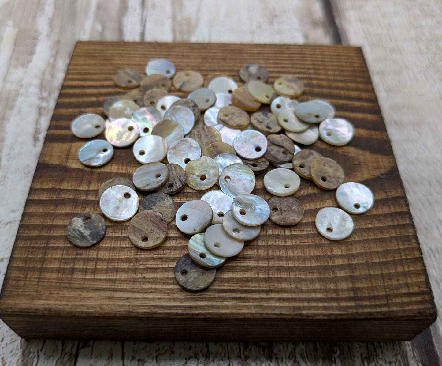 Top drilled abalone shell round beads.