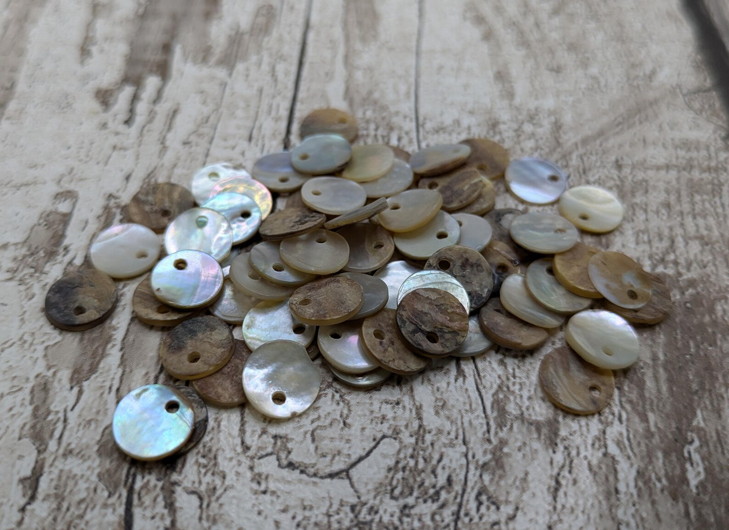 Top drilled abalone shell round beads.