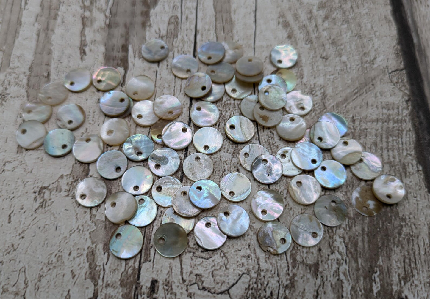 Top drilled abalone shell round beads.