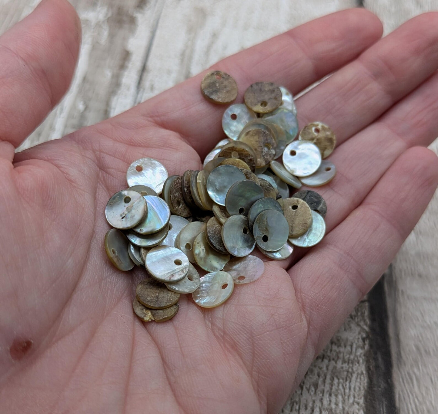 Top drilled abalone shell round beads.