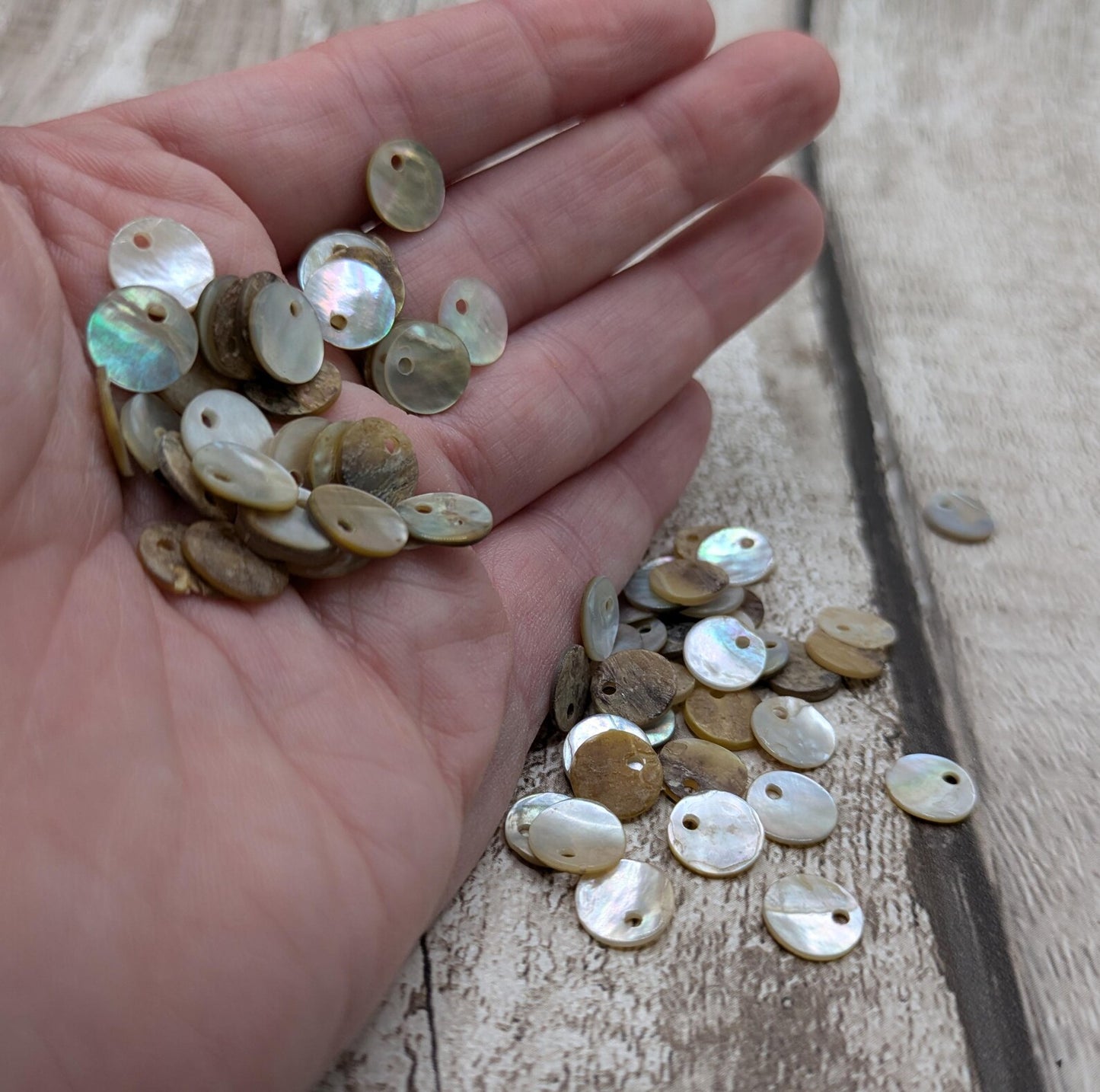 Top drilled abalone shell round beads.