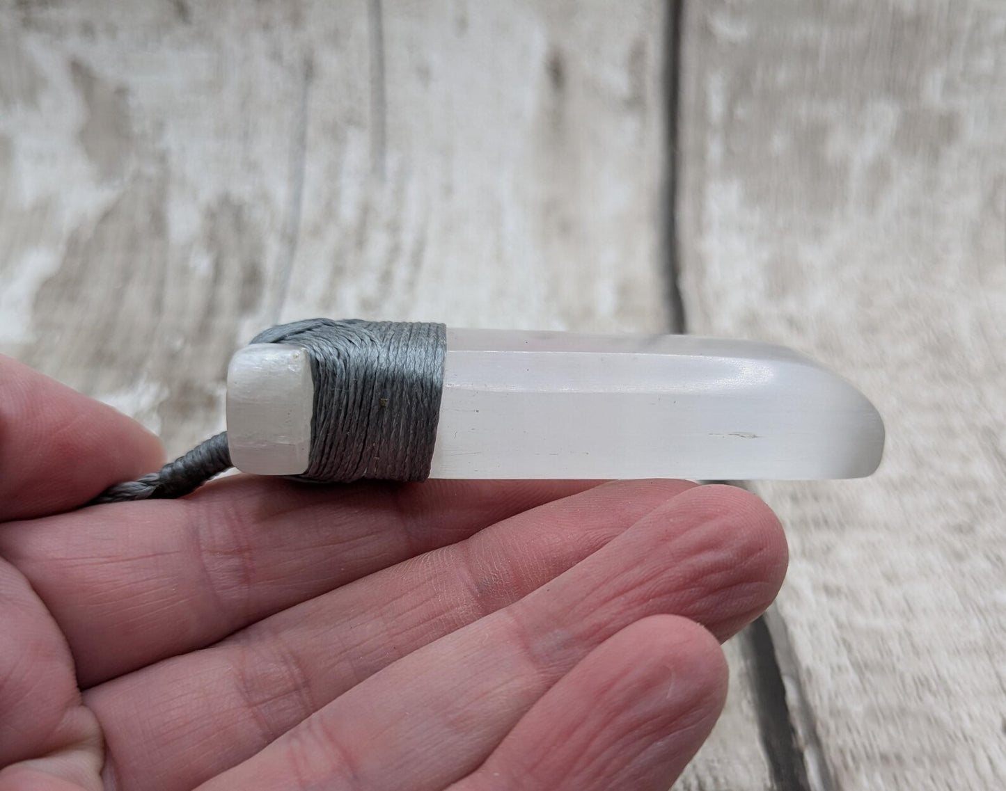 Selenite satin spar Hei Toki adze pendant.