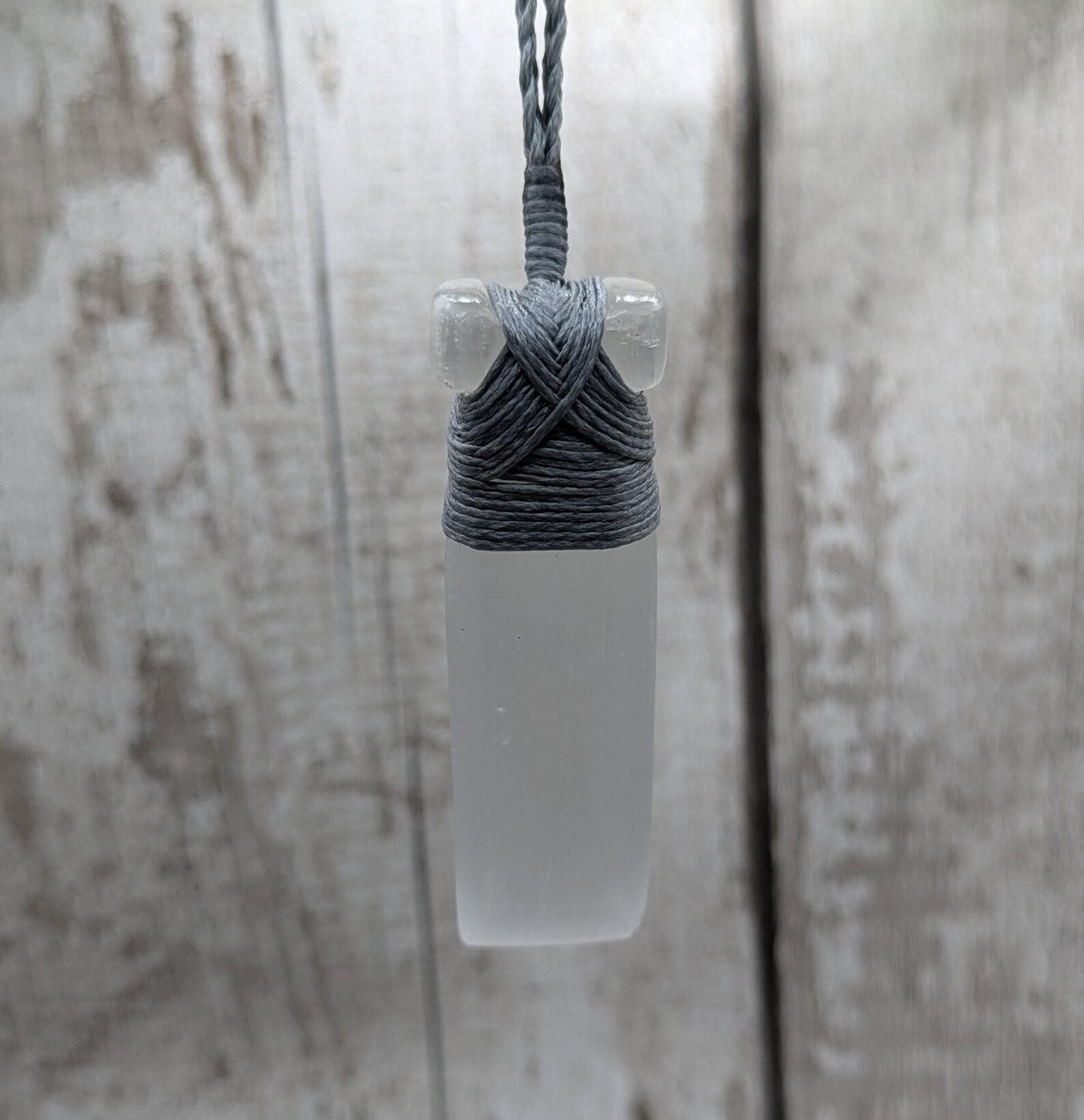 Selenite satin spar Hei Toki adze pendant.