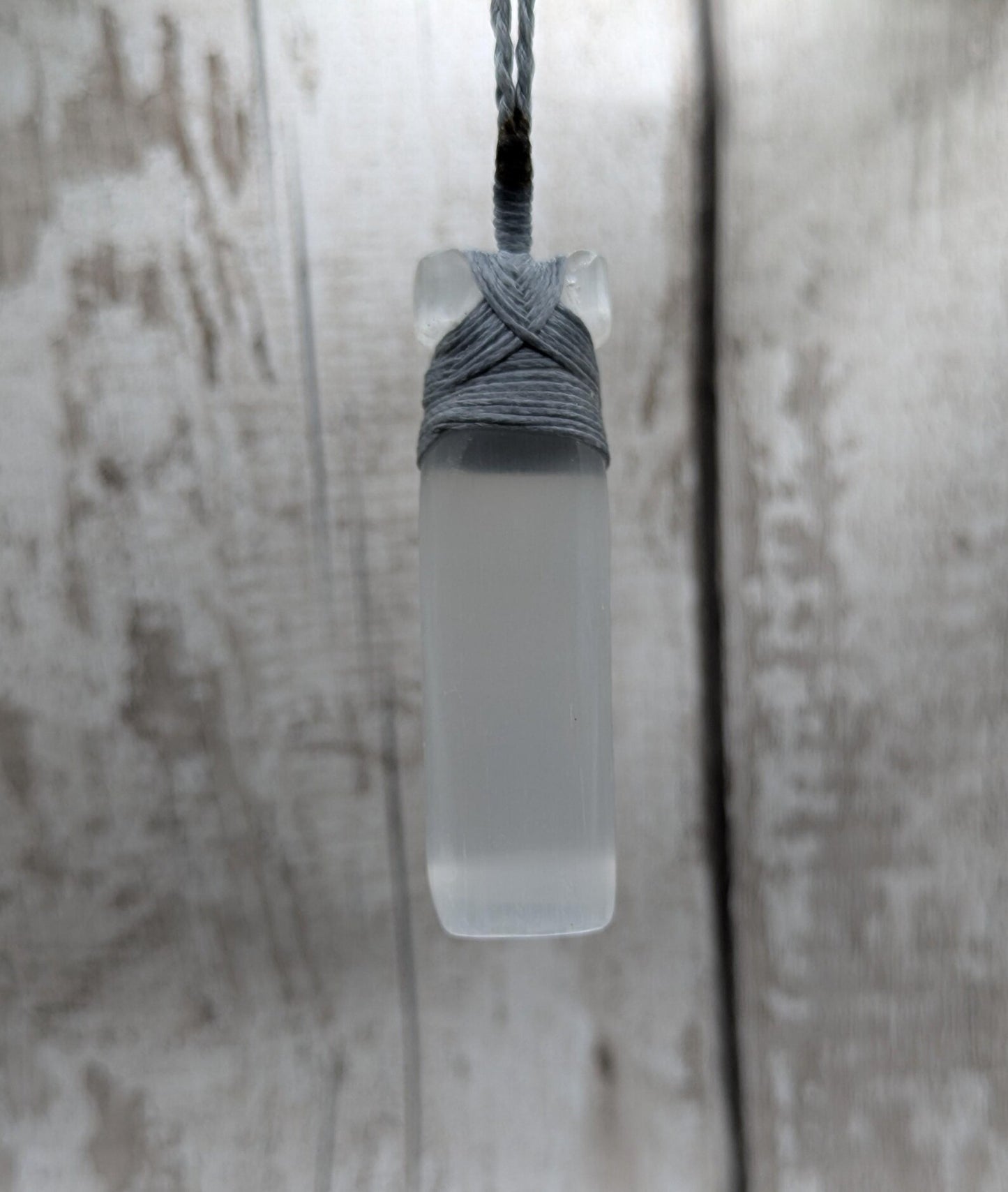Selenite satin spar Hei Toki adze pendant.