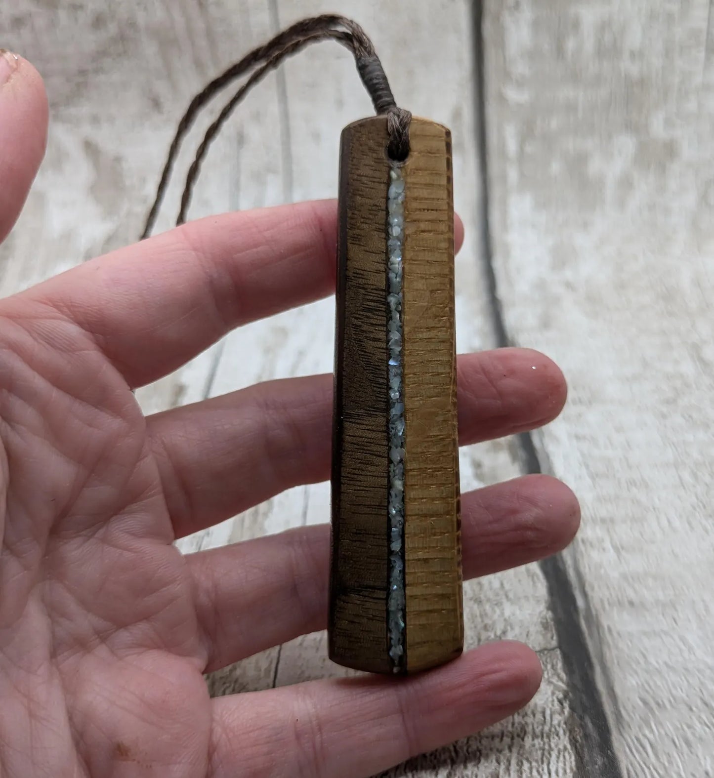 Walnut wood and whiskey barrel oak roimata pendant with freshwater Pearl.