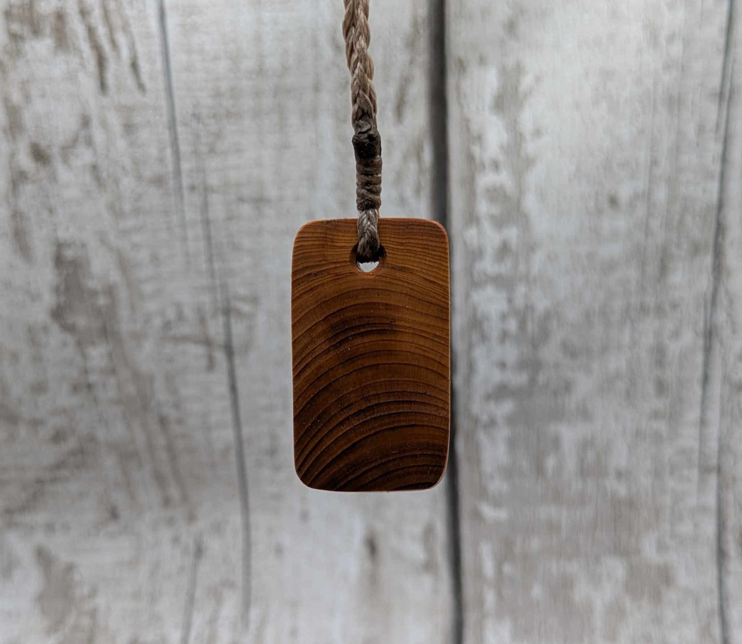 Yew wood Nauthiz rune pendant.