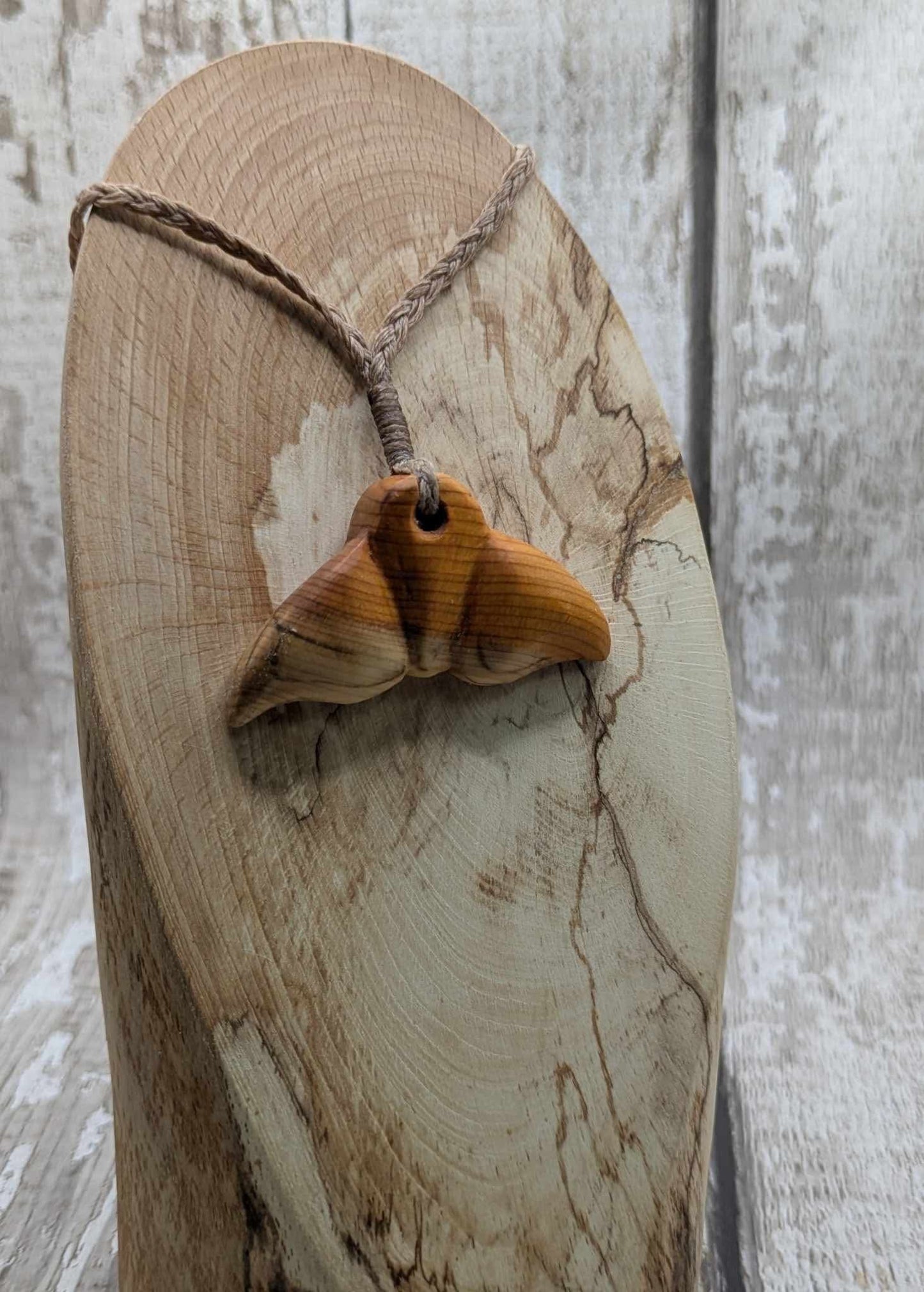 Yew wood whales tail pendant.