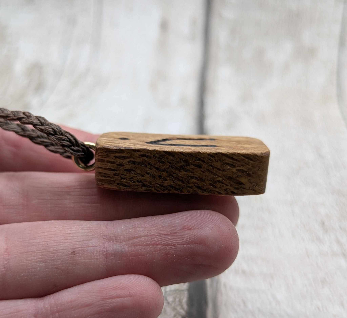 Olive wood uruz rune pendant.