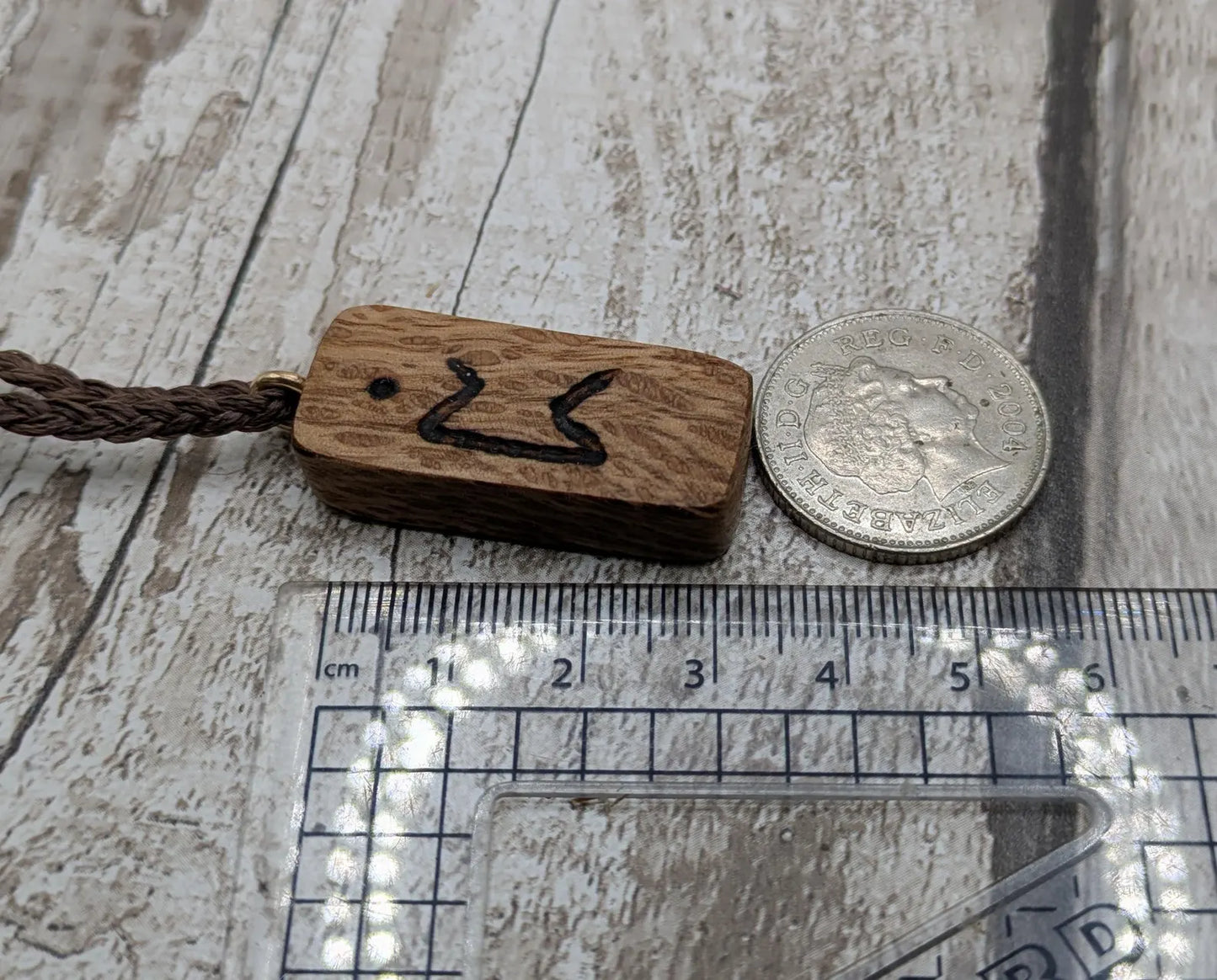Olive wood purthro rune pendant.
