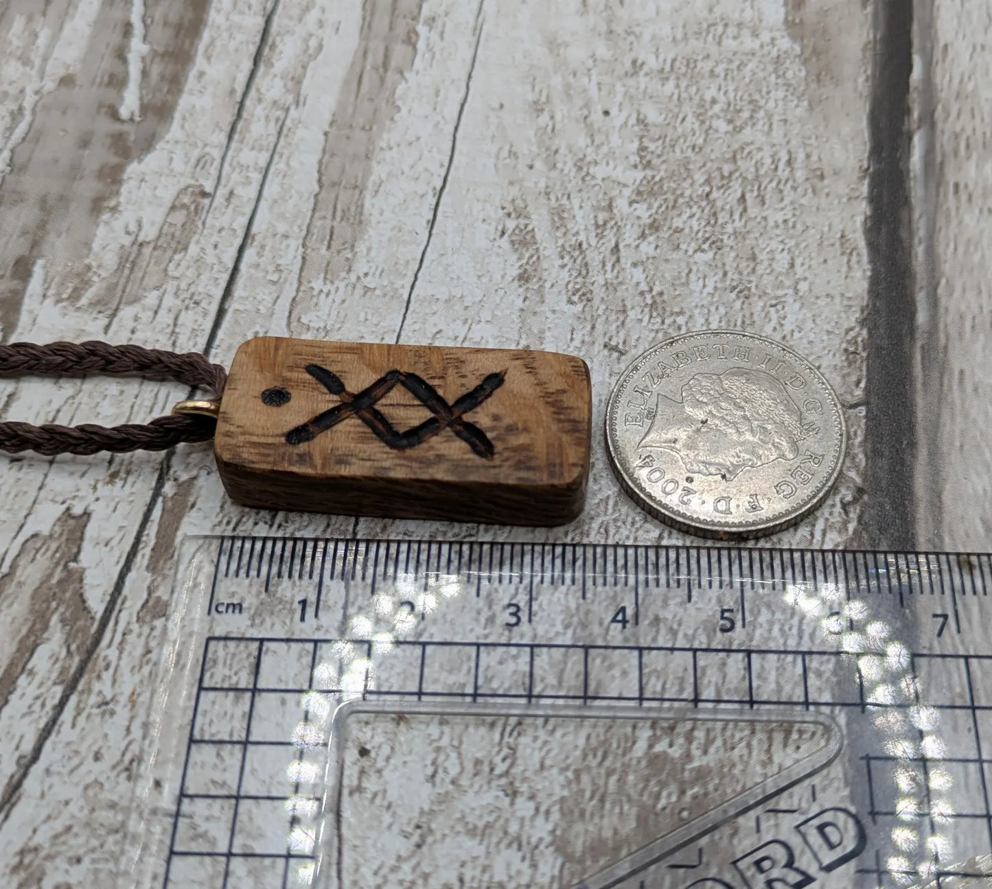 Olive wood ingwaz rune pendant.