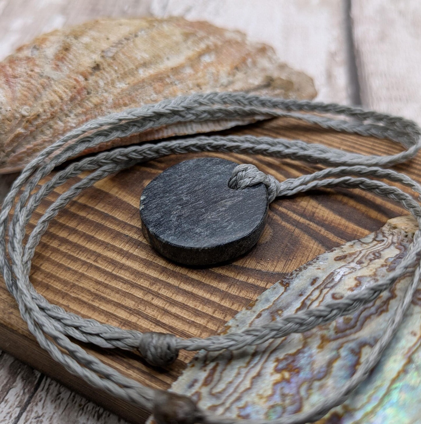 Low grade Shungite disc pendant, hight mica content.