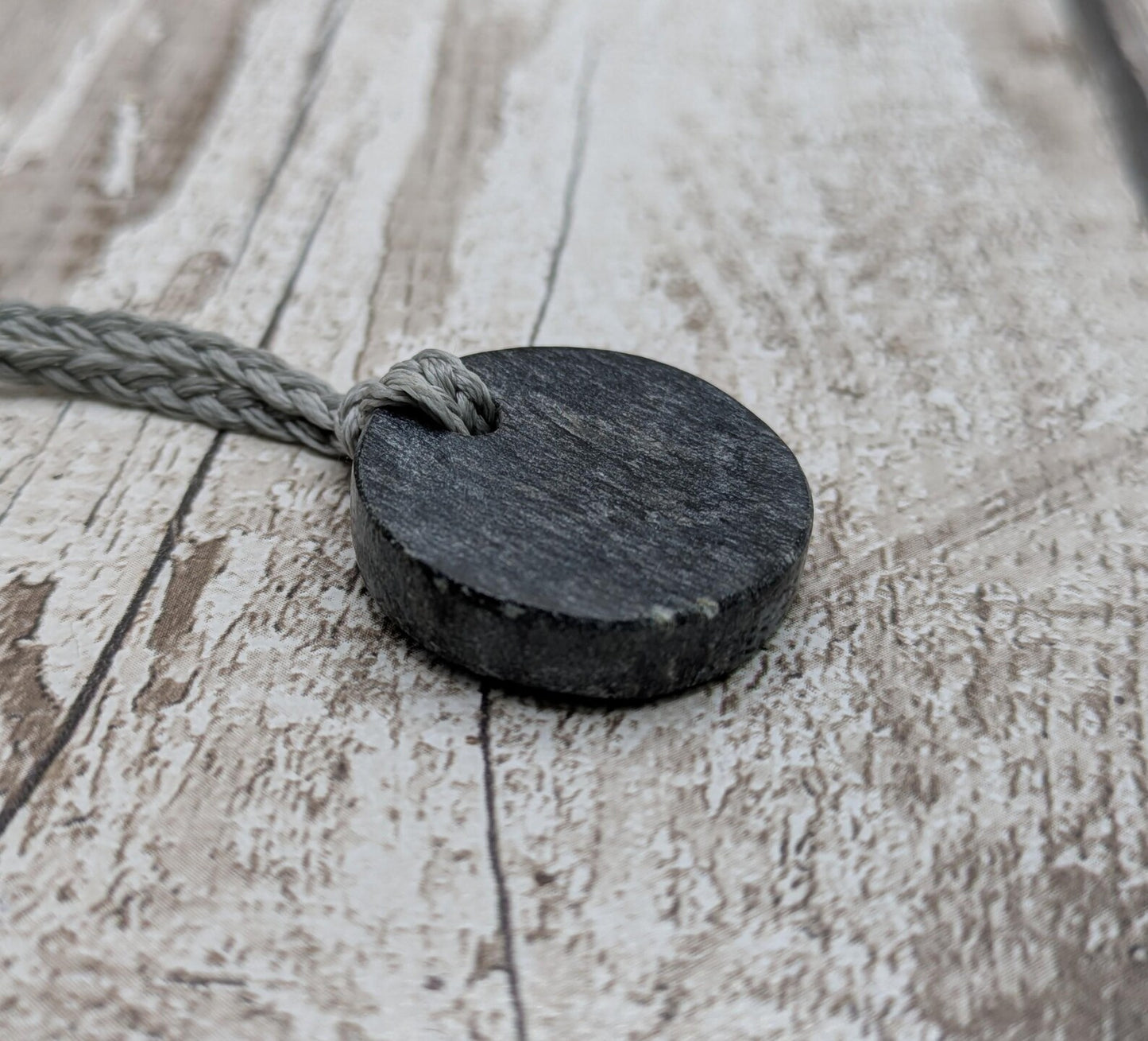 Low grade Shungite disc pendant, hight mica content.