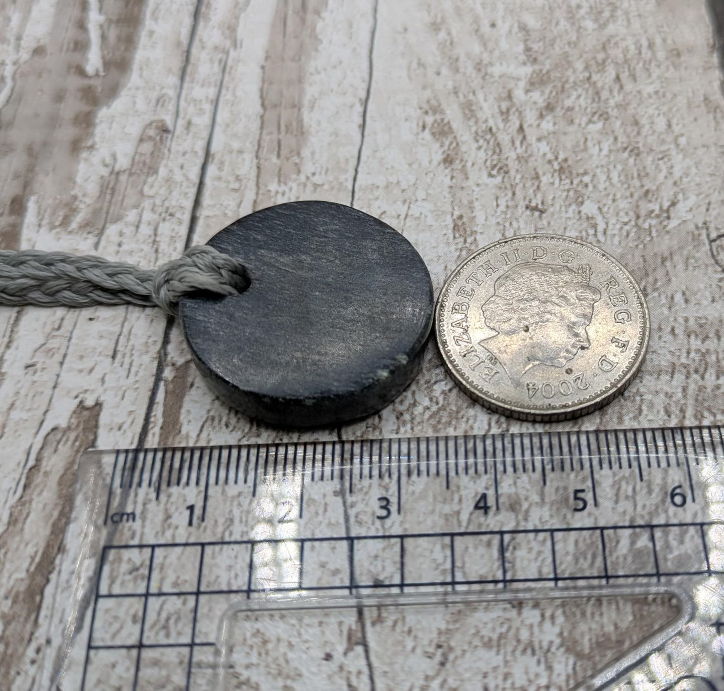 Low grade Shungite disc pendant, hight mica content.