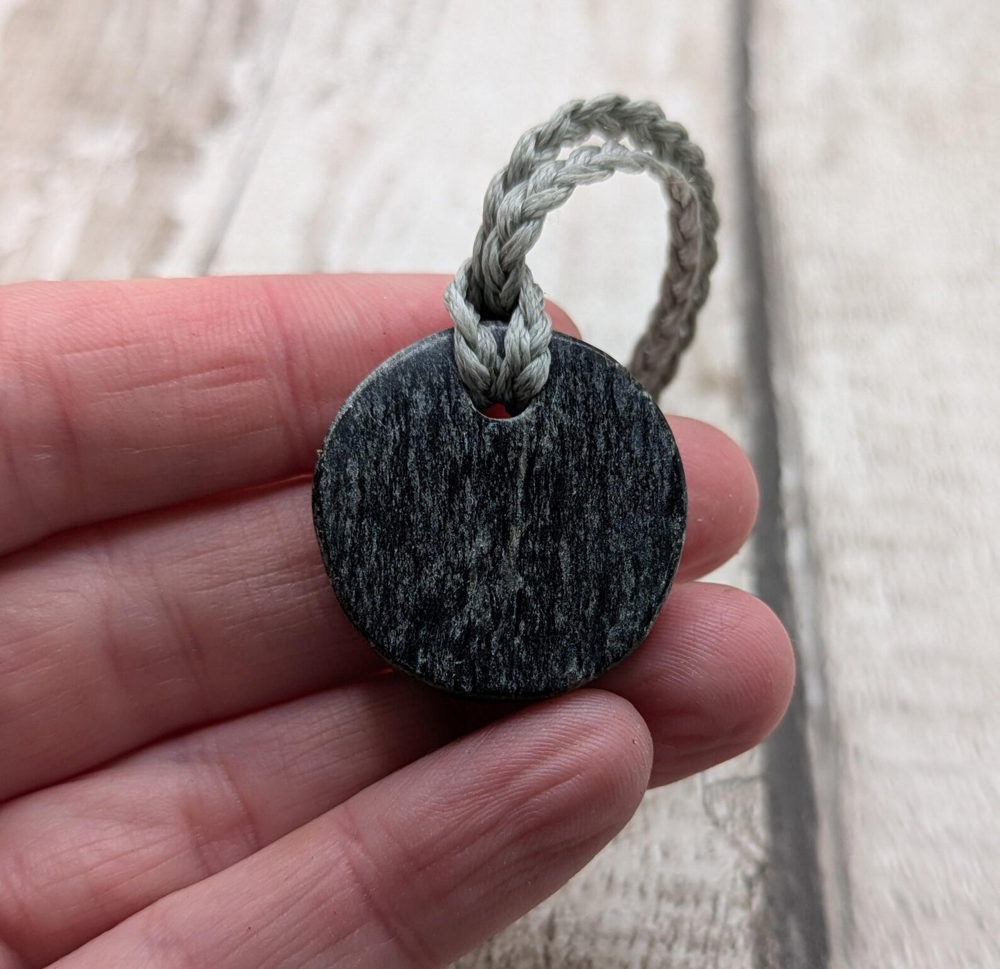 Low grade Shungite disc pendant, hight mica content.