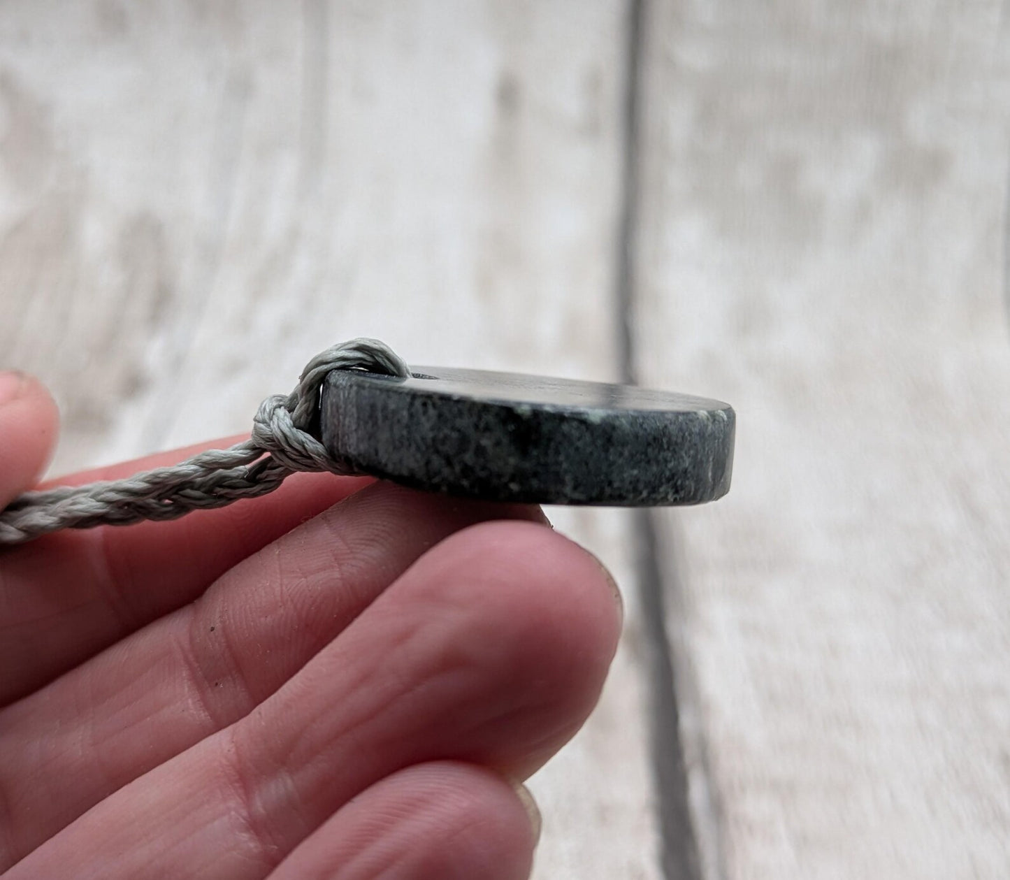 Low grade Shungite disc pendant, hight mica content.