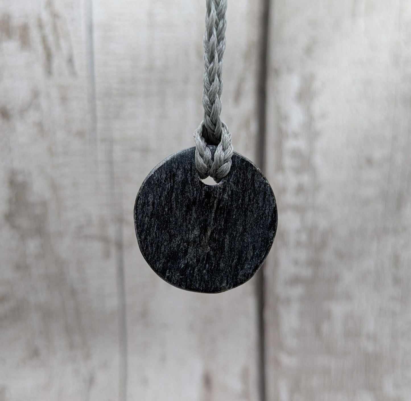 Low grade Shungite disc pendant, hight mica content.