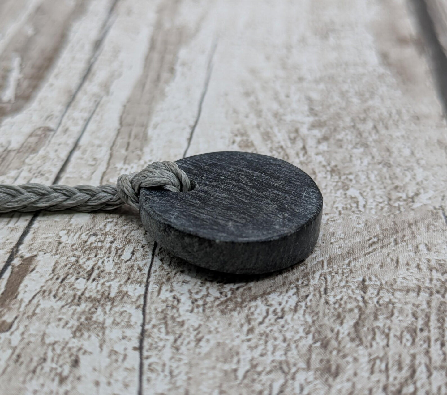 Low grade Shungite asymmetric disc pendants.