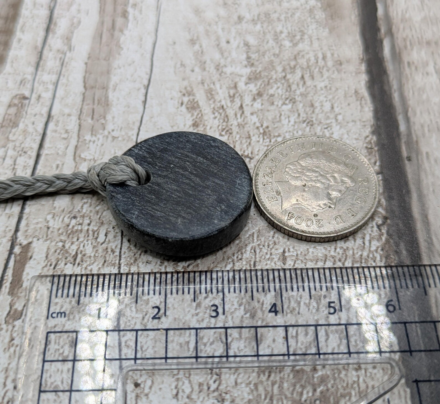 Low grade Shungite asymmetric disc pendants.