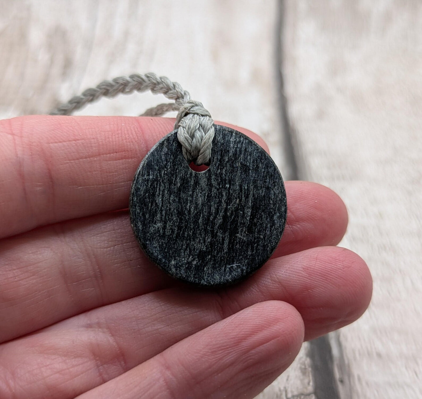 Low grade Shungite asymmetric disc pendants.
