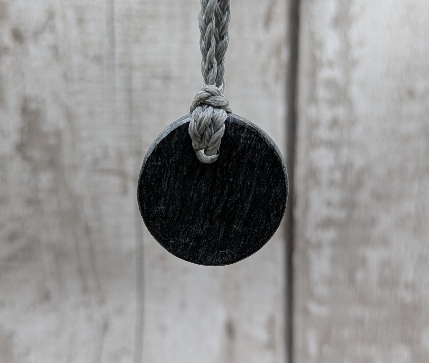 Low grade Shungite asymmetric disc pendants.